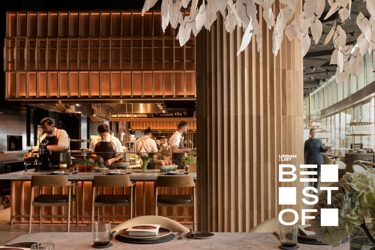 chefs at work in the open kitchen at woodcut, a barangaroo restaurant inside crown sydney